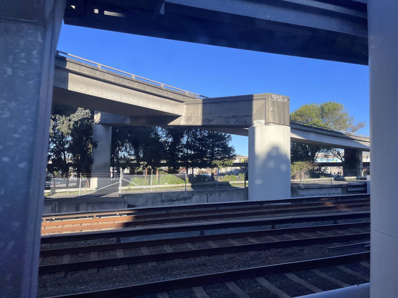 A view out the BART window. Elevated cement highways pass overhead.