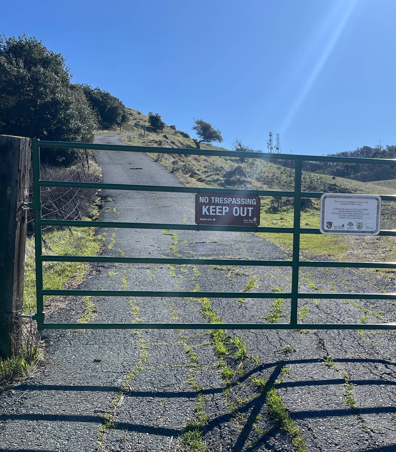 A gate with a no trespassing sign.